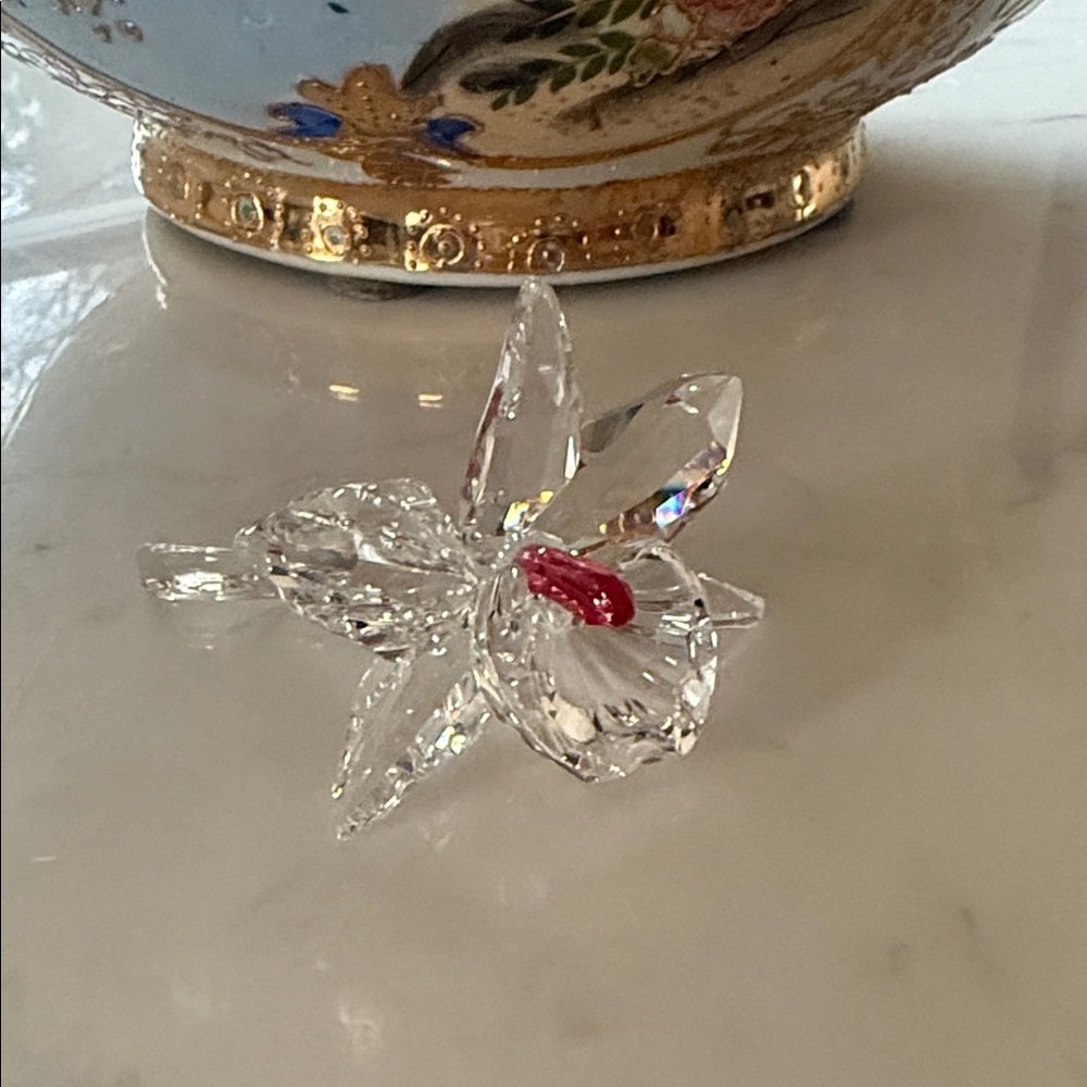 Swarovski retired Crystal orchid with Red Accent middle.